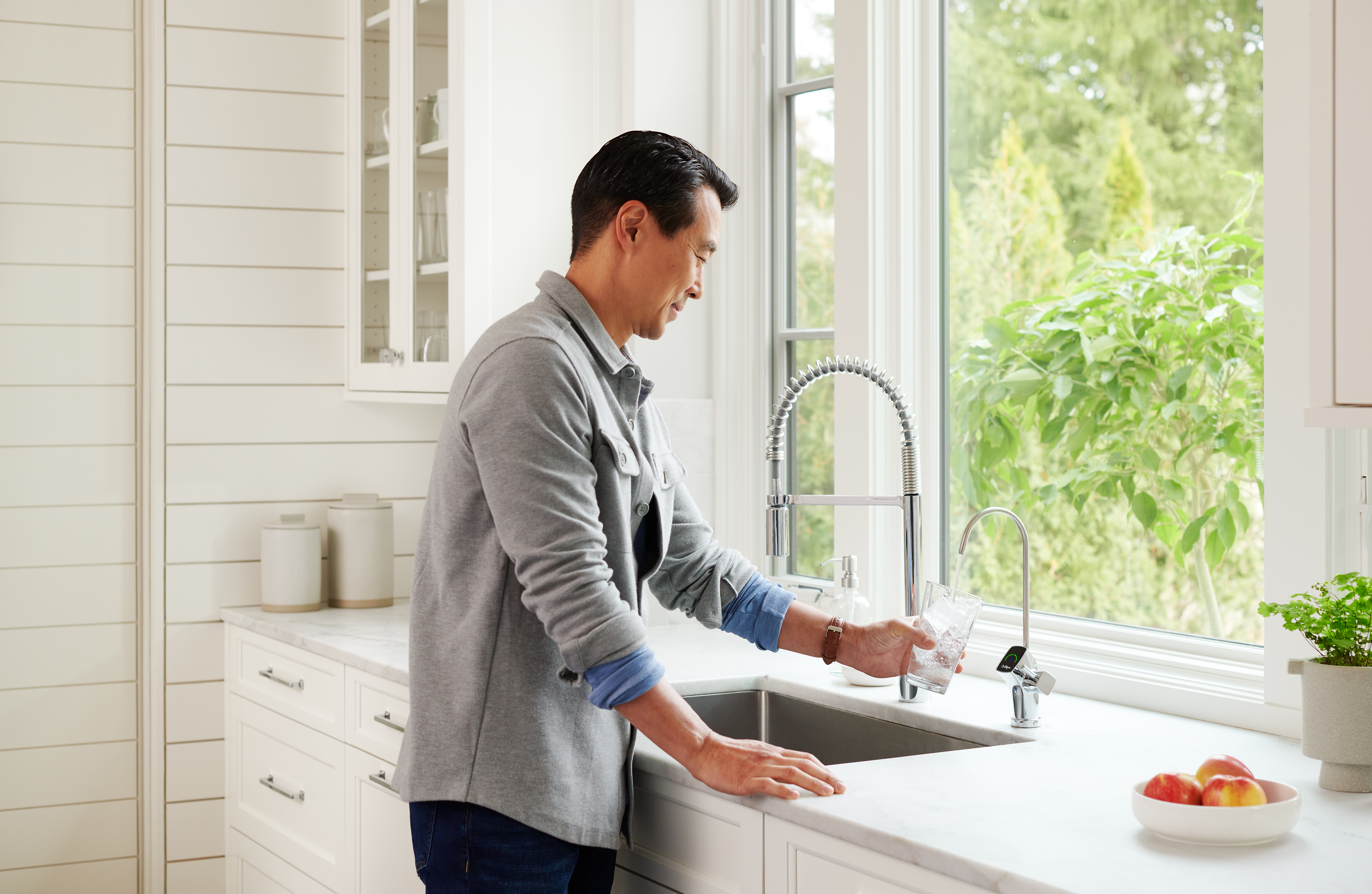 Filling up a cup of water from the kitchen sink